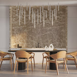 Modern dining room with six wooden chairs around a black table. A marble backsplash and abstract sculpture decorate the space, while the Micro LED Pendant Light - White hangs above for an elegant, refined look.