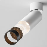 A modern cylindrical white ceiling fixture, the Focus LED Dimmable Single Spotlight 12W 3000K features a segmented design with an energy-efficient metallic honeycomb shade and glowing bulb inside.