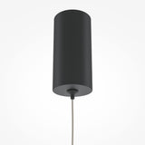 The Pro Base LED Thin Pendant Light - Black showcases a sleek cylindrical design with energy-efficient lighting, hanging by a single cable. Its dark gray hue complements the plain white background, highlighting its modern minimalist appeal.