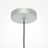 A close-up showcases the Pro Focus Thin Pendant Light - Silver, featuring a circular, polished ceiling canopy with a sleek black cord in its center, embodying modern design against a white backdrop.