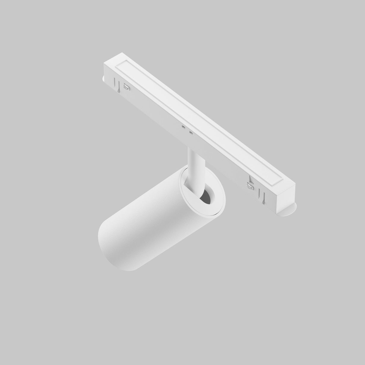 The Focus LED Magnetic Exility Track Spotlight 5W 4000K in white, with its sleek cylindrical design, adorns a light grey background on a linear track. Its minimalist elegance features an innovative magnetic system for easy installation.