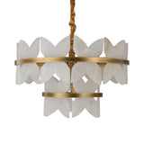 Niori Petraia two-tier chandelier with sculpted white alabaster petals on brushed brass rings, suspended from a gold fabric cable against a white background.