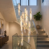 Grenoble LED 13 Light Blade Alabaster Chandelier in brass, flat alabaster blades cascading at staggered heights above a stairwell landing.