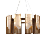 Niori Caelith LED large round chandelier with stepped Spanish alabaster panels and brushed brass blades, suspended on steel cables against white.