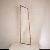 Niori Atria Small LED alabaster floor lamp with tapered brushed brass frame and circular white marble base against a neutral background.