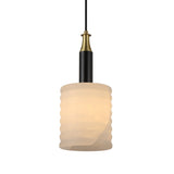 Niori Bellaro pendant light with ridged soft white alabaster cylindrical shade, black stem and brushed brass collar, on a plain white background.