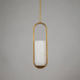 Eliona Capsule Alabaster Pendant Light in brushed brass with a vertical stone cylinder suspended inside a slim capsule frame on a light grey background.