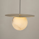 Marenzo Alabaster Orb Pendant Light in Brushed Brass, featuring a 300mm alabaster sphere lit from within beneath a flat brass disc, shown against a plain light background.