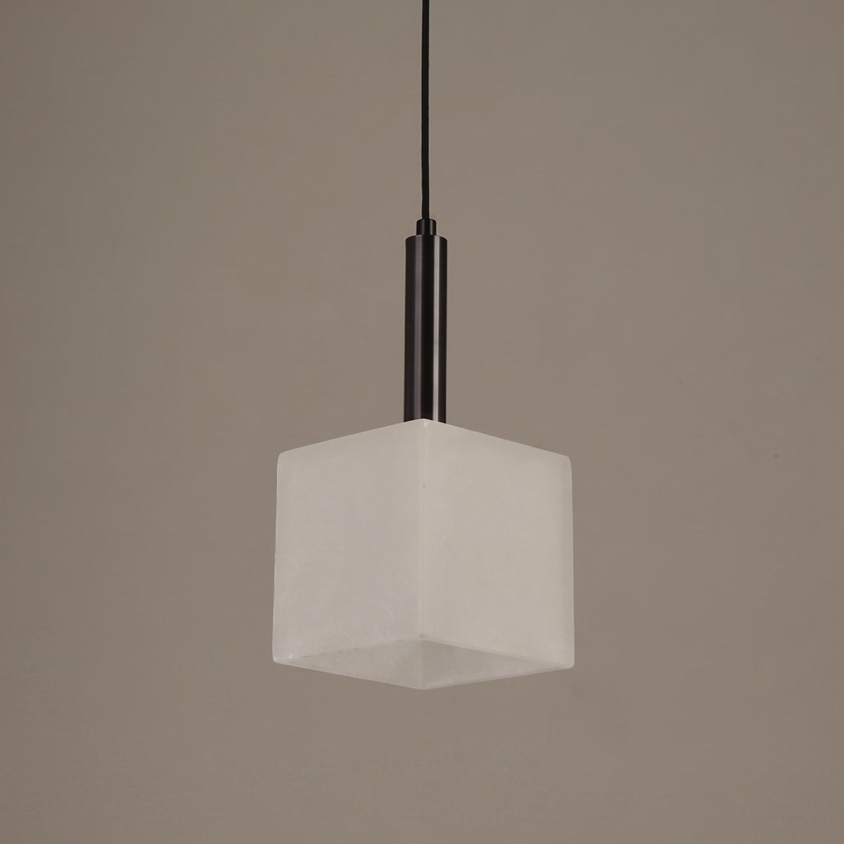 Draxen alabaster drum pendant light with cube-shaped white shade and matte black stem, shown against a plain grey background.