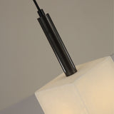 Close-up of the Draxen alabaster drum pendant light, showing the faceted alabaster shade meeting a matte black cylindrical stem with brushed brass collar, on a plain neutral background.