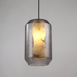 Vale Faceted Alabaster Pendant Light in Soft White, a lantern-shaped fixture with a glowing alabaster column inside faceted clear glass, black flex cord, shown on a plain grey background.