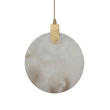 Niori Luna LED alabaster disc pendant light with brushed brass bracket and pin suspension, shown against a plain white background.