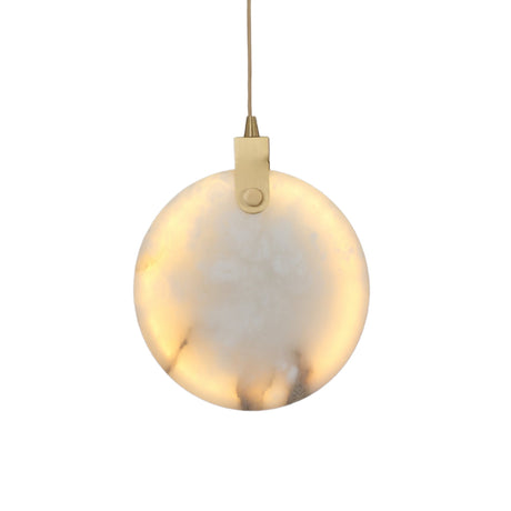 Niori Luna LED Medium 250mm alabaster disc pendant illuminated with warm light, brushed brass hinge and suspension cable, on a plain white background.