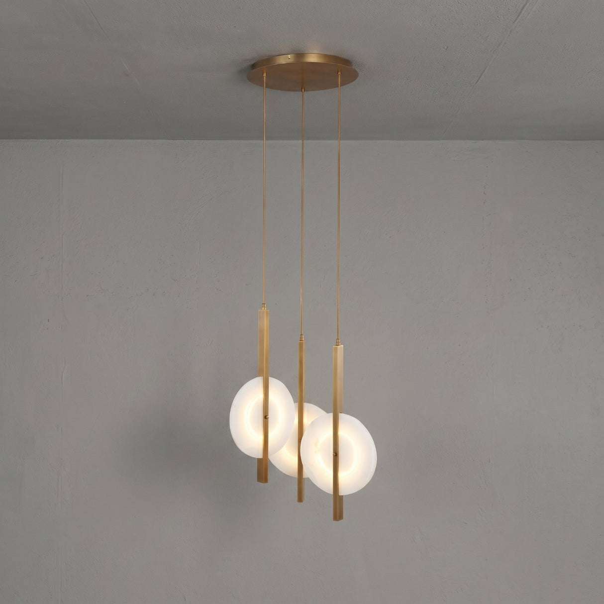 Niori Elyra 3 Light LED Alabaster Cluster Chandelier in brushed brass with three staggered alabaster discs on slender blade stems and a round canopy.