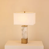 Ravelle Alabaster Column Table Lamp with fluted stone base, brushed brass accents, and rectangular soft white fabric shade.