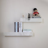 Niori Kate Small LED alabaster wall shelf light in soft white, styled with books, rabbit figurines and a guardsman bear on a neutral wall.
