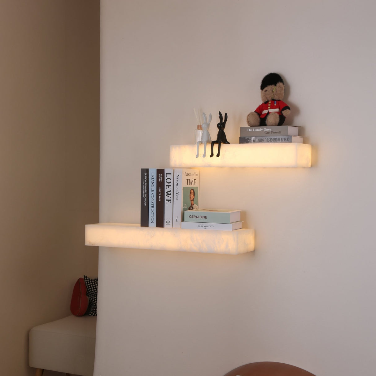 Niori Kate LED alabaster wall shelf lights in soft white, mounted in pairs displaying books, figurines and a guardsman teddy in a softly lit corner.