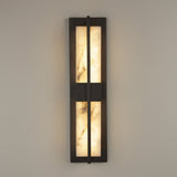 Niori Caldera LED wall light in matt black with two vertical Spanish alabaster panels split by a central bar, mounted on a pale wall.