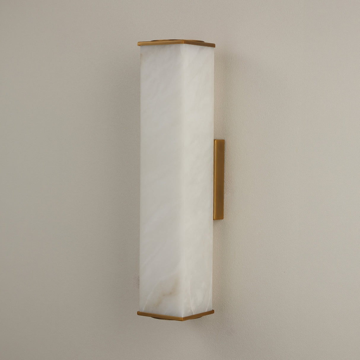 Valmere LED Small Linear Alabaster Wall Light in Soft White, a rectangular natural alabaster panel with brass end caps and mounting bracket, shown on a plain neutral wall.