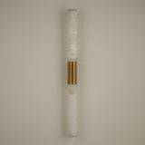 Niori Eryon LED large wall light with two natural Spanish alabaster cylinders joined by a ribbed brushed brass mount, mounted on a pale wall.