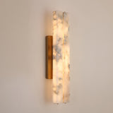 Selvara LED Large Alabaster Double Wall Light in Brushed Brass, two vertical alabaster columns glowing warm white on a slim brass backplate, mounted on a plain light wall.