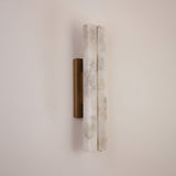 Selvara LED Medium Alabaster Double Wall Light with two vertical natural alabaster bars on a brushed brass backplate, mounted on a plain neutral wall.