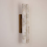 Selvara LED Large Alabaster Double Wall Light with two vertical alabaster columns on a brushed brass backplate, mounted on a plain light wall.