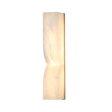 Vera LED Small Silhouette Alabaster Wall Light in soft white, an elongated hourglass-shaped column with brushed brass edge detail, illuminated from within, shown on a plain white background.