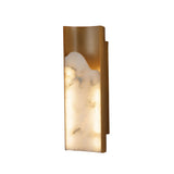 Niori Caelith LED large wall light with a tall carved Spanish alabaster panel in a brushed brass frame, shown lit against a white background.