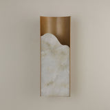 Caelith medium carved alabaster wall light by Niori with a tall Spanish alabaster slab set in a brushed brass frame on a neutral wall.