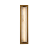 Niori Valora vertical wall light with tall illuminated alabaster panel set in a brushed brass rectangular backplate with cleat fixings, on white.