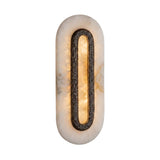 Ovaline LED oval wall light with a hammered brass ring set into a tall stadium-shaped alabaster plate, glowing warm white on a plain background.