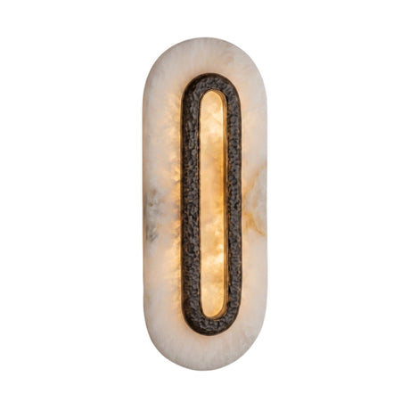 Ovaline LED oval wall light with a hammered brass ring set into a tall stadium-shaped alabaster plate, glowing warm white on a plain background.
