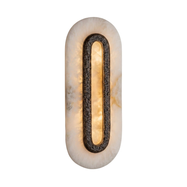 Ovaline LED oval wall light with a hammered brass ring set into a tall stadium-shaped alabaster plate, glowing warm white on a plain background.