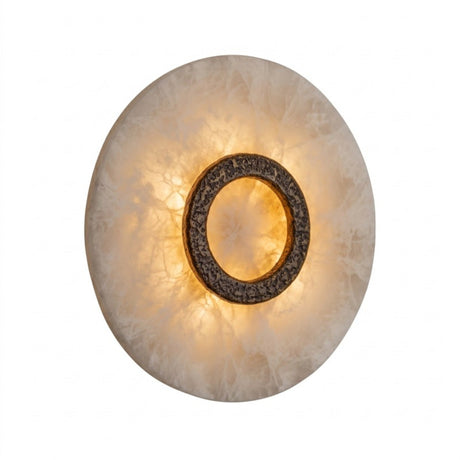 Ovaline round LED wall light with a domed alabaster disc and hammered brushed brass ring, glowing warmly against a plain white background.