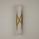 Valora LED Alabaster Wall Light with brushed brass crossover bands wrapping a cylindrical alabaster column, mounted on a plain light background.