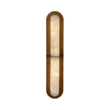 Niori Eliora LED alabaster wall light with brushed brass rounded-end surround, central horizontal bar dividing two lit stone panels, on white background.