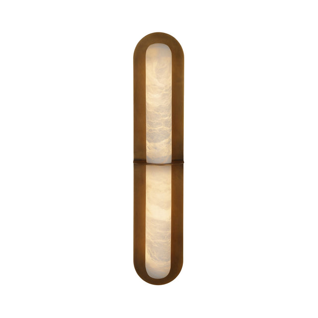 Niori Eliora LED alabaster wall light with brushed brass rounded-end surround, central horizontal bar dividing two lit stone panels, on white background.