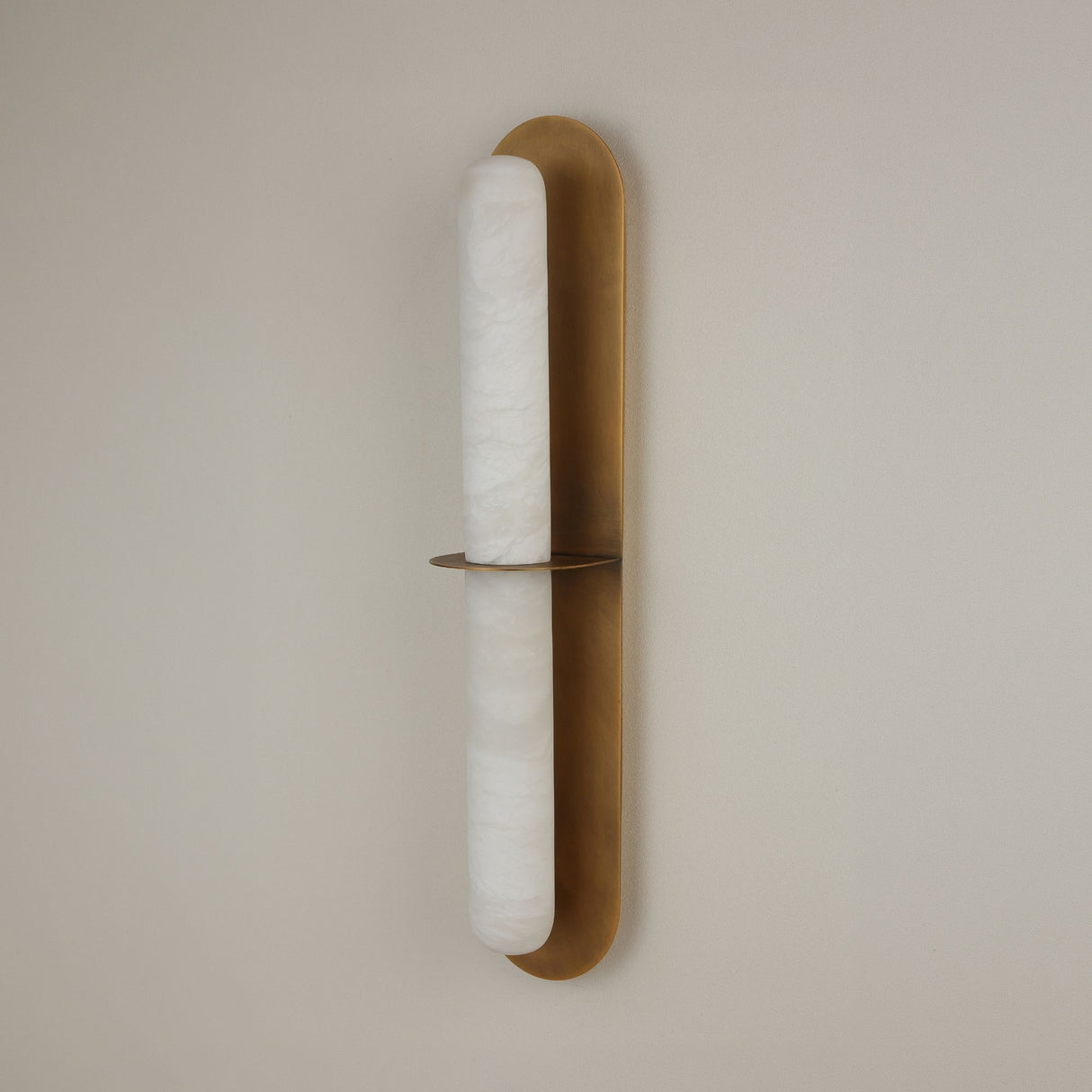 Niori Eliora LED wall light with a natural Spanish alabaster column framed in a brushed brass surround, divided by a central horizontal bar.