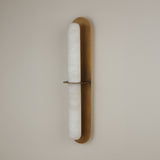 Niori Eliora LED wall light with a natural Spanish alabaster column framed in a brushed brass surround, divided by a central horizontal bar.