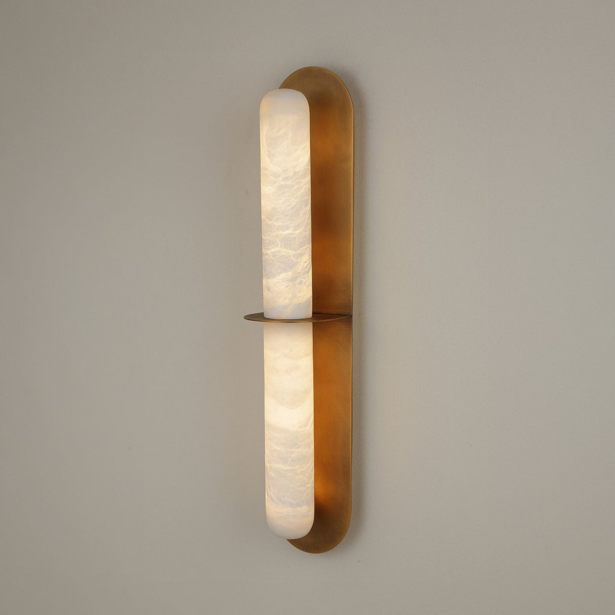 Niori Eliora LED alabaster wall light in brushed brass, vertical fixture with two stacked alabaster sections divided by a horizontal brass bar.