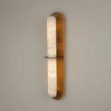 Niori Eliora LED alabaster wall light in brushed brass, vertical fixture with two stacked alabaster sections divided by a horizontal brass bar.