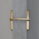 Aurevon LED wall light with vertical alabaster panel and brushed brass backplate, horizontal brass bar detail, close-up view on grey background.