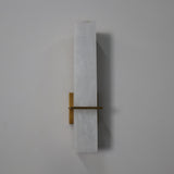 Aurevon LED Alabaster Vertical Panel Wall Light in Brushed Brass, elongated stone panel with horizontal brass arm and backplate, on a plain white background.