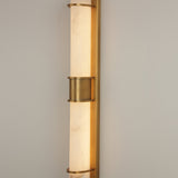 Averna LED framed alabaster wall light by Niori, with stacked cylindrical alabaster columns held in a brushed brass frame and central collar.