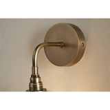 Otoro Recycled Glass Wall Light in Clear, close-up of the round brass wall plate with two fixing screws and curved brass arm, ribbed collar visible above the glass shade.
