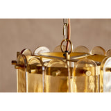 Close-up of the Itan Tiered Recycled Glass Pendant Light in amber, showing brass rings and fittings holding rounded glass paddles, suspended from a rust braided flex.
