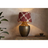 Haadu Large Jute Kilim Lampshade in rust and natural wool, fitted to a bronze textured table lamp base in a living room setting.