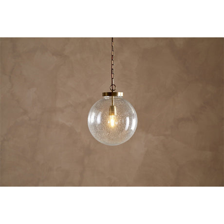Jayeda Recycled Glass Ball Pendant Light in clear bubbled glass, 30.5cm globe with brass cap and antique brass chain, shown lit against a plain brown background.
