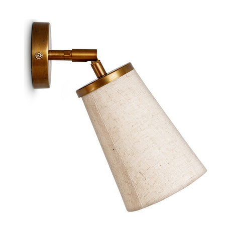 Ame Linen Wall Spotlight in off white, a brass wall light with round backplate, adjustable knuckle joint, and tapered fabric shade, shown on a plain white background.